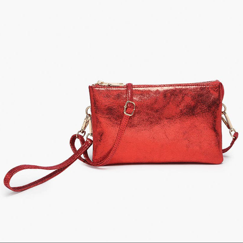 Red metallic handbag with a strap on a white background