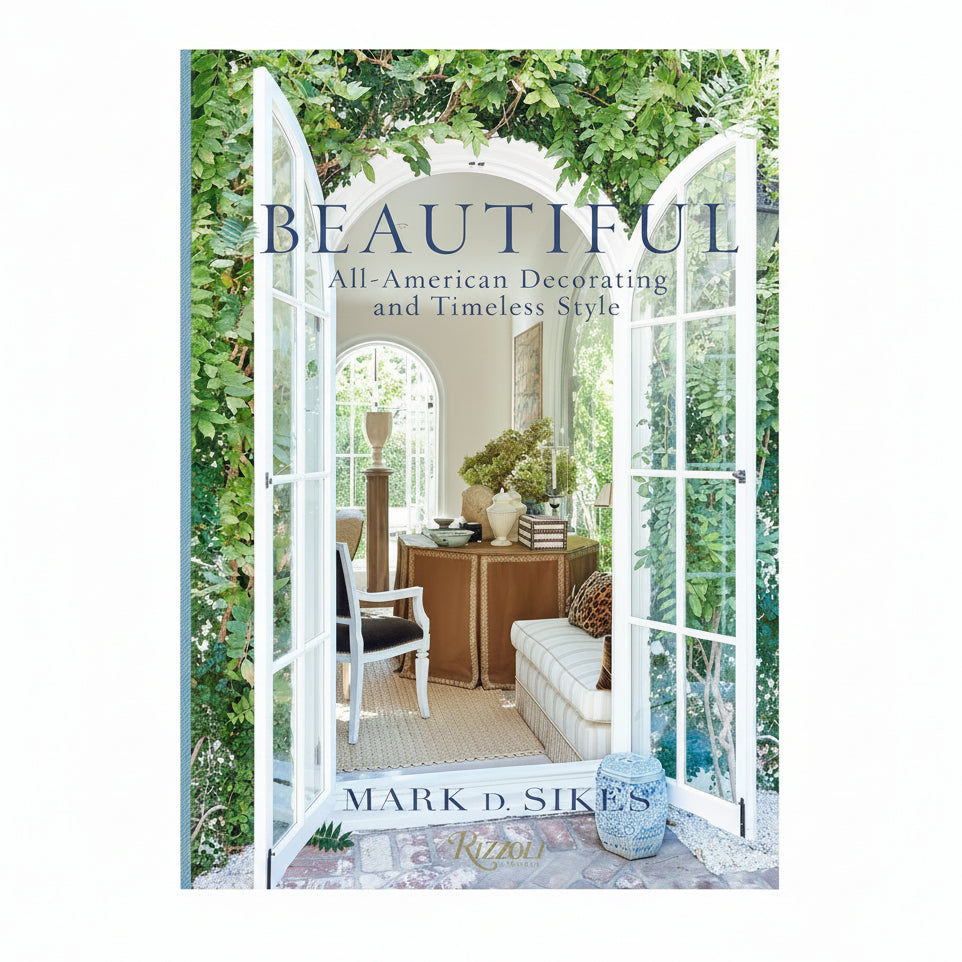 Book cover of 'Beautiful: All-American Decorating and Timeless Style' by Mark D. Sikes with a scenic view through open doors.