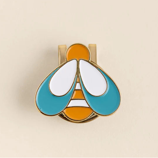 Colorful butterfly-shaped clip on a beige background