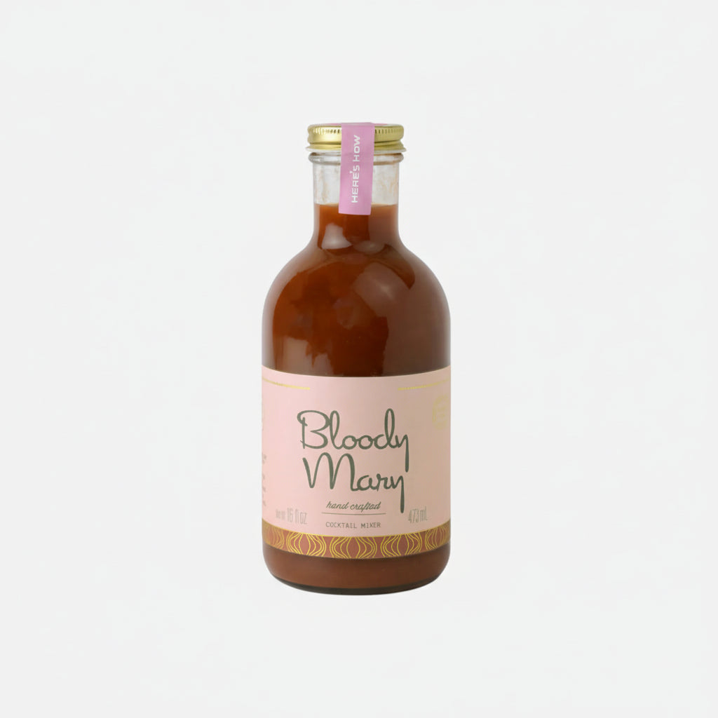 Bottle of Bloody Mary mix with a pink label on a white background