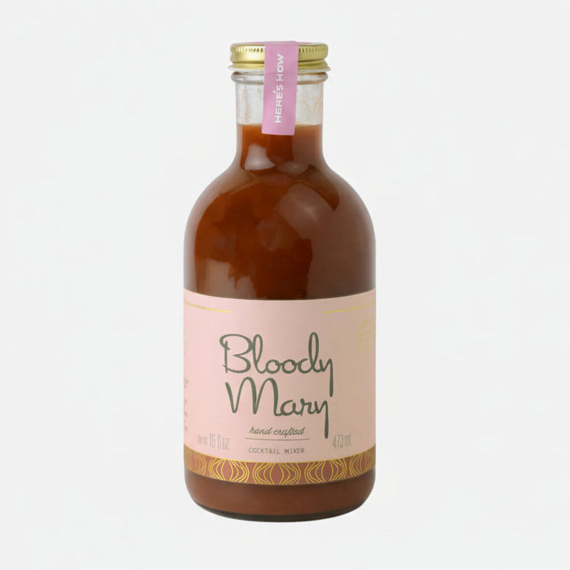 Bottle of Bloody Mary mix with a pink label on a white background