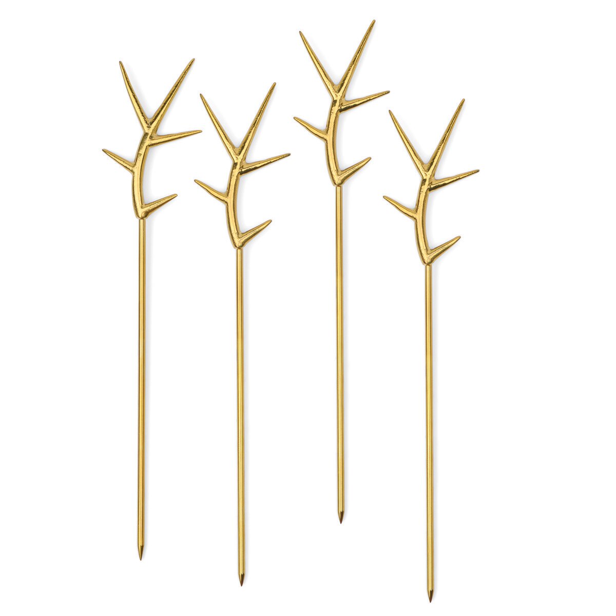 Four gold branch-shaped picks on a white background