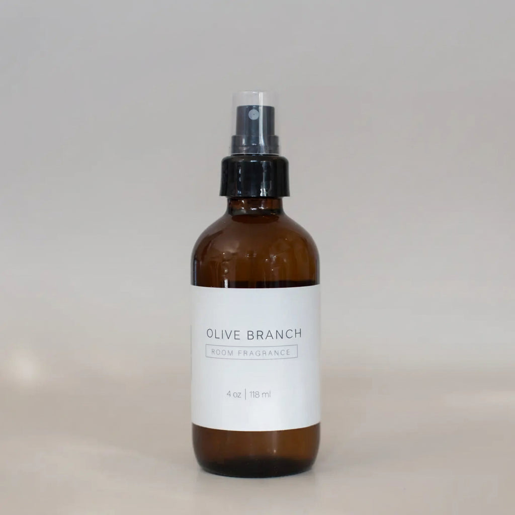 Brown spray bottle labeled 'OLIVE BRANCH' on a light gray background