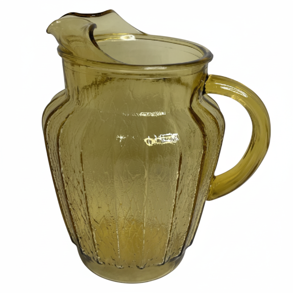Yellow glass pitcher on a white background