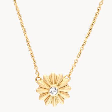 Gold necklace with a sunflower-shaped pendant on a white background