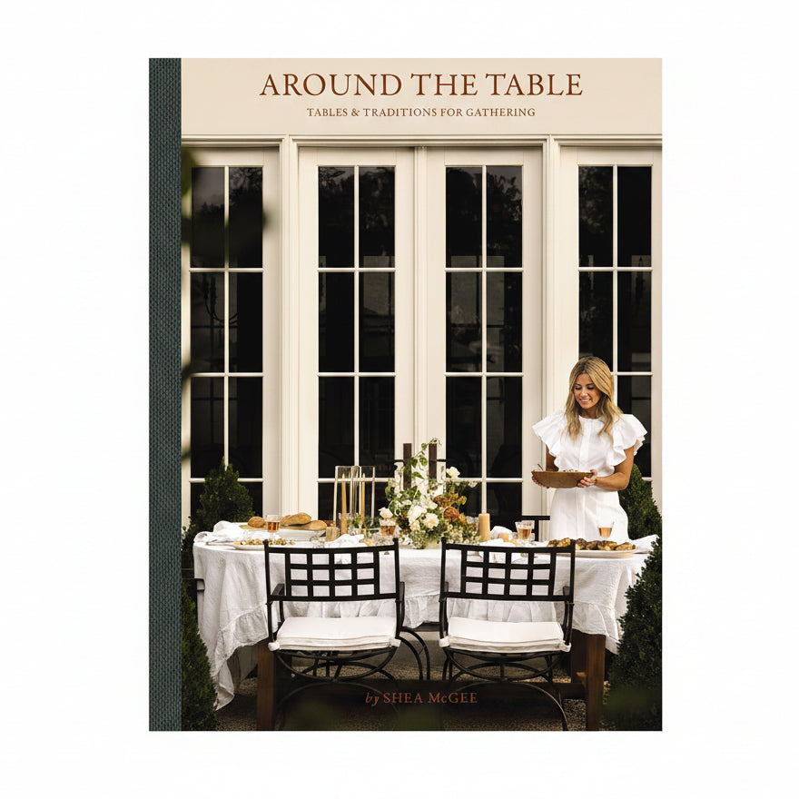 Book cover of 'Around the Table' with a woman at an outdoor dining table.
