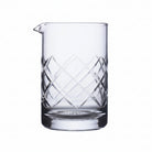 Clear glass pitcher with geometric patterns on a white background