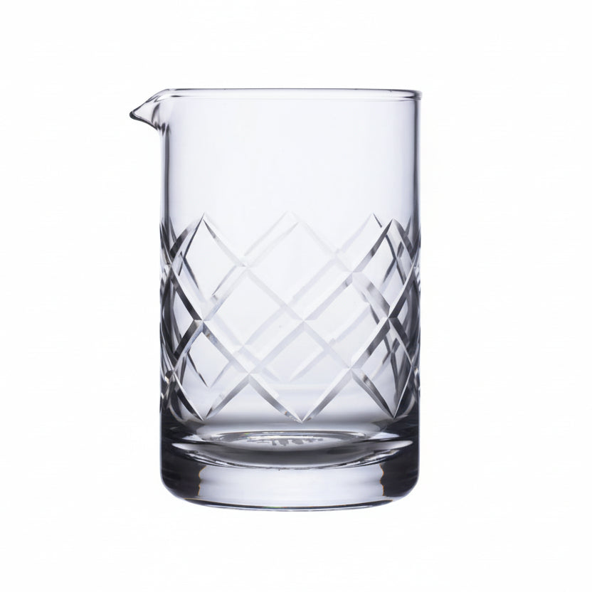 Clear glass pitcher with geometric patterns on a white background