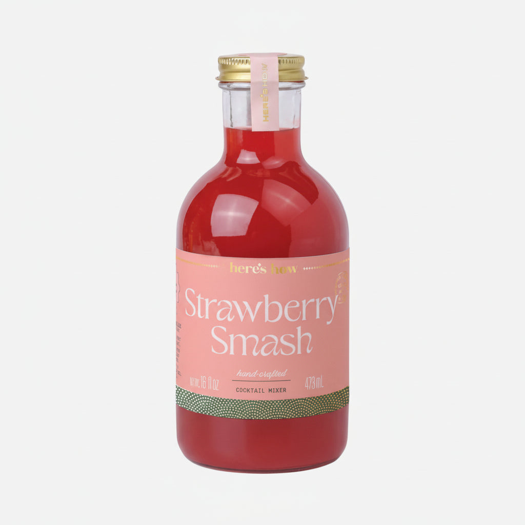 Bottle of strawberry smash cocktail mixer with a pink label on a white background