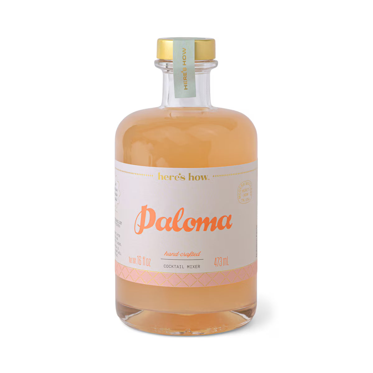 Bottle of Paloma cocktail mixer with a gold cap on a white background