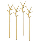 Four gold branch-shaped picks on a white background