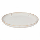 White ceramic plate with a gold rim on a white background
