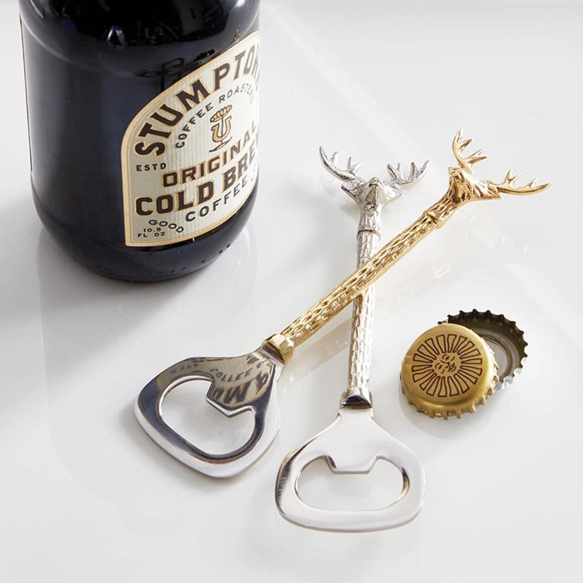 Bottle opener with antler design next to a bottle of Stumptown coffee on a white surface.