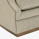 Close-up of a beige upholstered chair with striped pattern on a white background