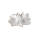 White ceramic dish with ruffled edges on a white background