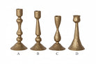 Set of four gold candle holders on a white background