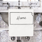 Decorative wall with metallic fixtures and a sign reading 'Home'.