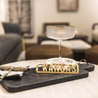 Decorative tray with 'KANSAS' sign on a table in a living room setting