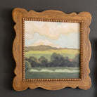 FurnishHere natural wood framed landscape painting with green hues and beaded edge detail.