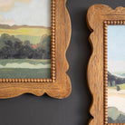 FurnishHere natural wood framed landscape acrylic painting with beaded edge detail and wavy frame. Rich green hues and sky.
