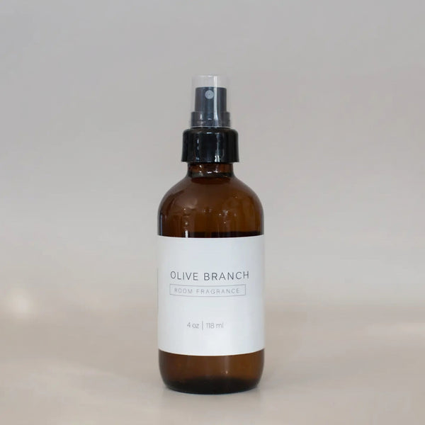 Brown spray bottle labeled 'OLIVE BRANCH' on a light gray background