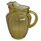Yellow glass pitcher on a white background