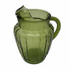 Green glass pitcher on a white background